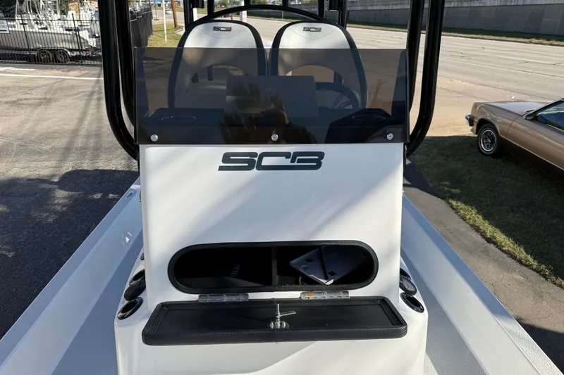 Slide: The Image of 2018 SCB Recon boat console with seating and storage, parked outdoors. - 25