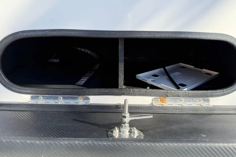Slide: The Image of Open storage compartment of 2018 SCB Recon boat with latch and interior view. - 26