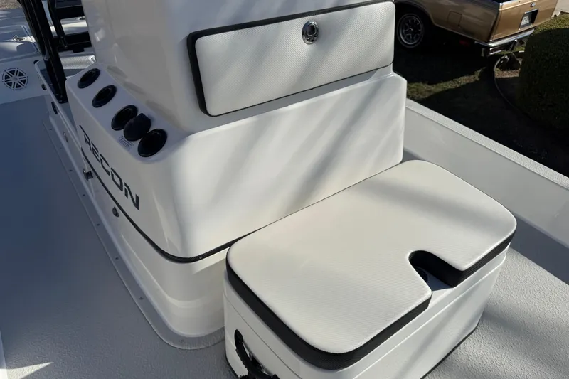 Slide: The Image of 2018 SCB Recon boat console with storage and seating, featuring sleek white design. - 27