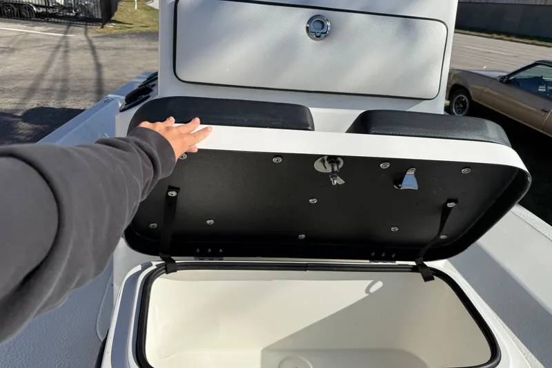 Slide: The Image of Person opening storage compartment on 2018 SCB Recon boat. - 28