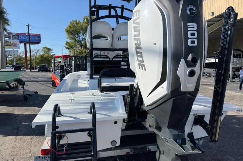 Slide: The Image of 2018 SCB Recon boat with Evinrude 300 engine, parked outdoors. - 3