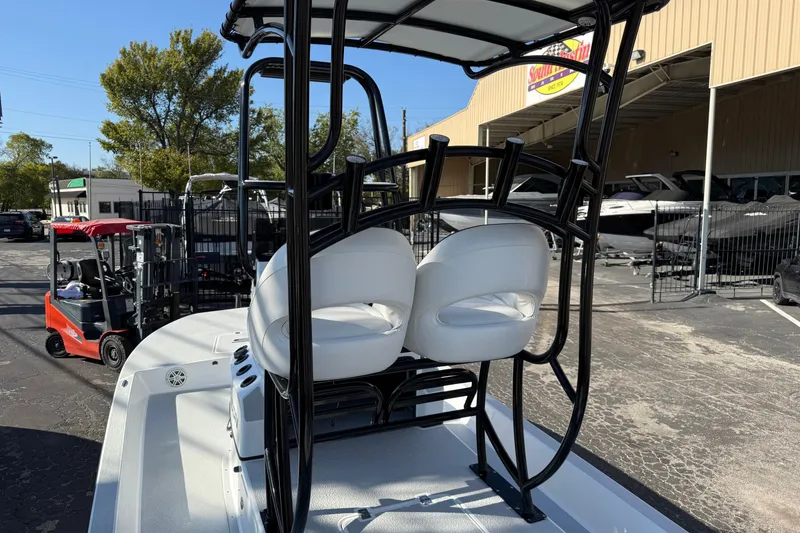 Slide: The Image of 2018 SCB Recon boat with dual white seats and black frame, parked outside dealership. - 33