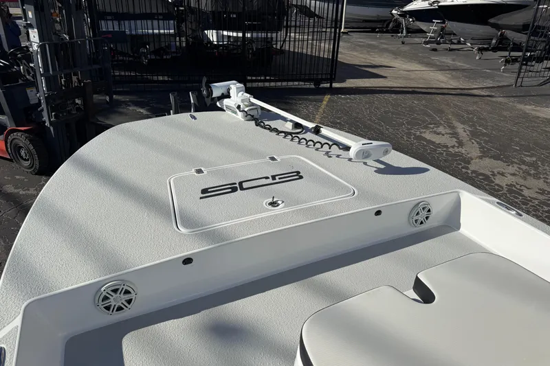 Slide: The Image of 2018 SCB Recon boat deck with trolling motor in a marina setting. - 42