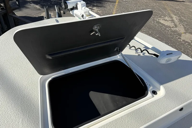 Slide: The Image of 2018 SCB Recon boat hatch open, revealing storage compartment on textured deck. - 45
