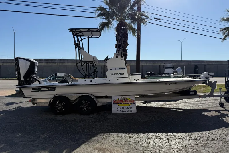 Slide: The Image of 2018 SCB Recon boat on trailer, parked outdoors near palm trees. - 49