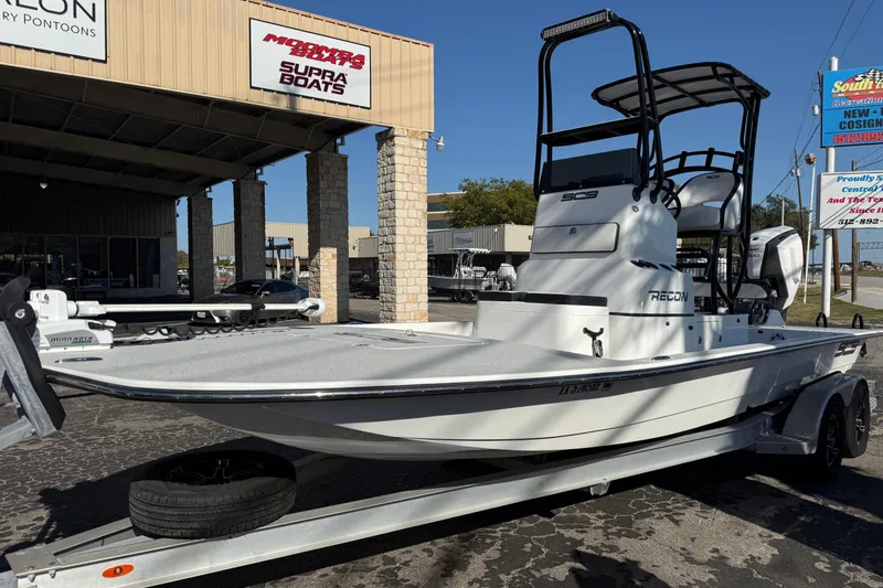 Slide: The Image of 2018 SCB Recon boat on trailer outside dealership, showcasing sleek design and modern features. - 5