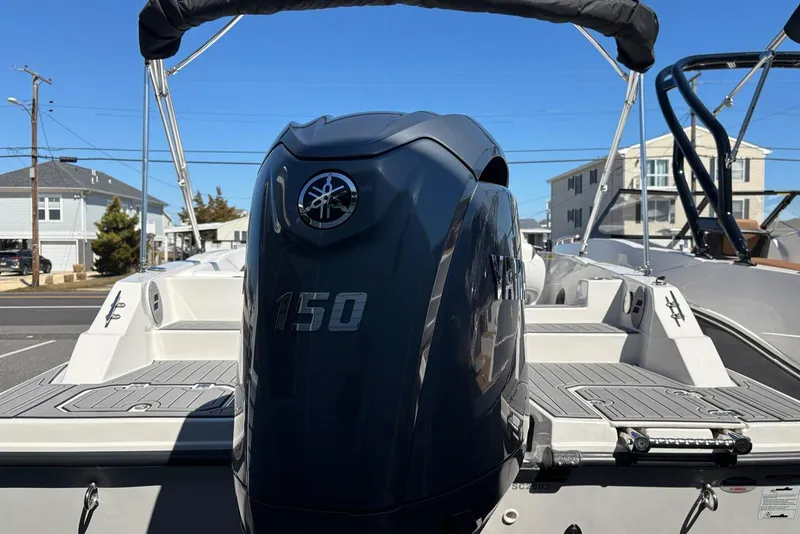 Slide: The Image of 2026 Starcraft SVX 211 OB DC boat with Yamaha 150 outboard motor, docked outdoors. - 12