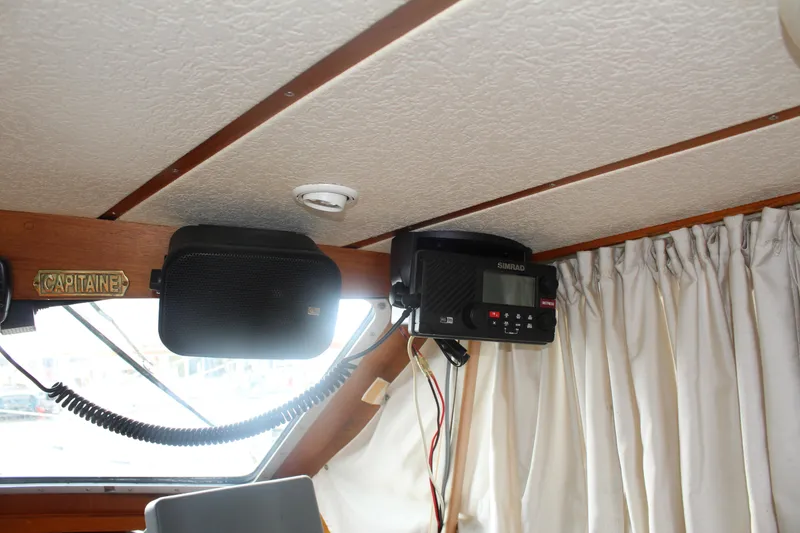 Slide: The Image of Interior of 1998 Nauticat 32 Pilothouse with radio and speaker setup. - 16
