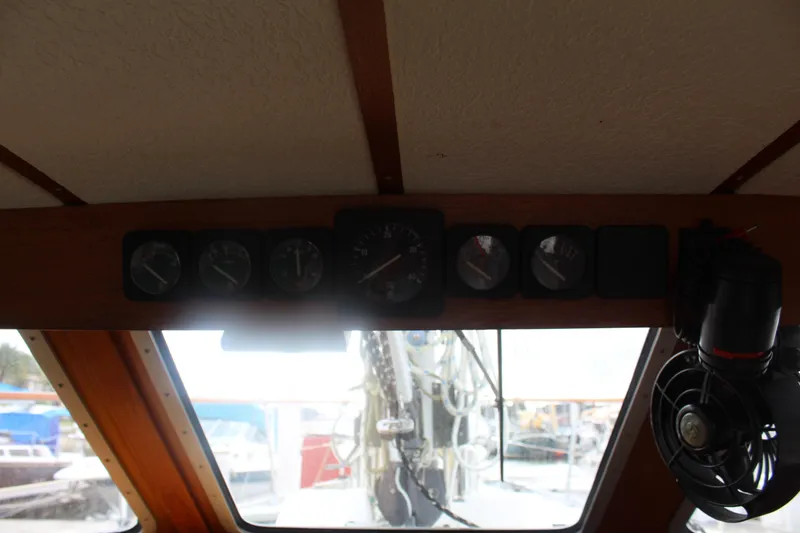 Slide: The Image of Pilothouse interior of 1998 Nauticat 32, featuring navigation instruments and a fan. - 17