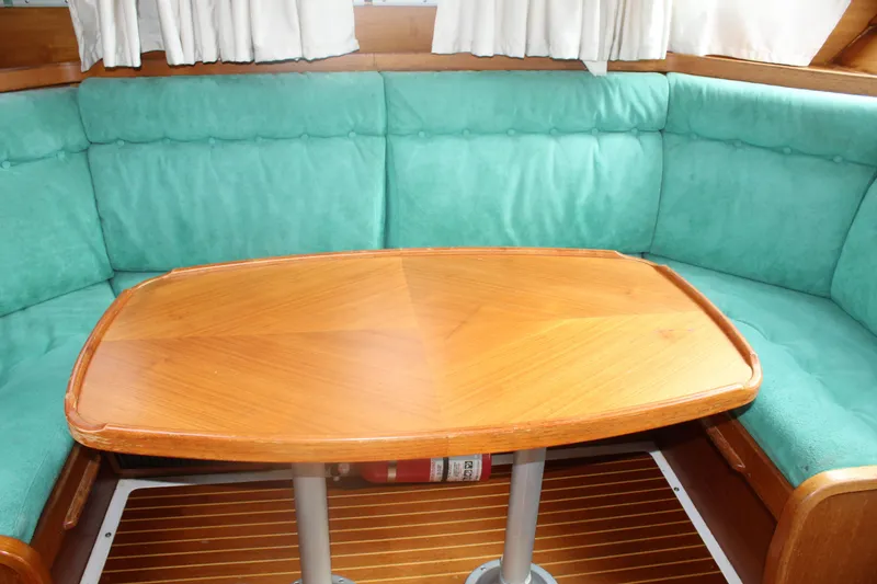Slide: The Image of Interior of 1998 Nauticat 32 Pilothouse with wooden table and teal seating. - 18