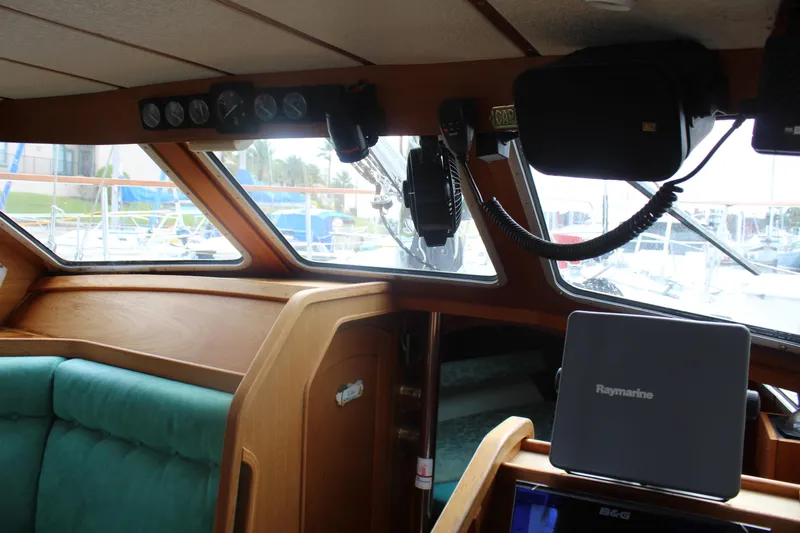 Slide: The Image of Interior of 1998 Nauticat 32 Pilothouse with navigation equipment and green seating. - 19
