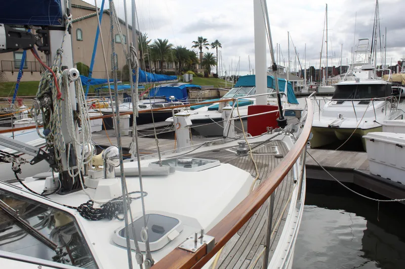 Slide: The Image of 1998 Nauticat 32 Pilothouse sailboat docked in a marina, surrounded by other boats. - 29
