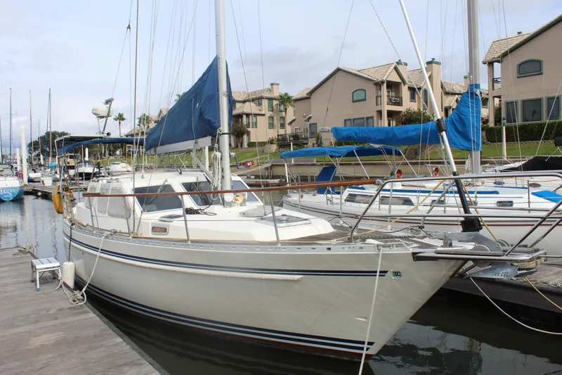 Slide: The Image of 1998 Nauticat 32 Pilothouse sailboat docked at marina with blue sail cover. - 3