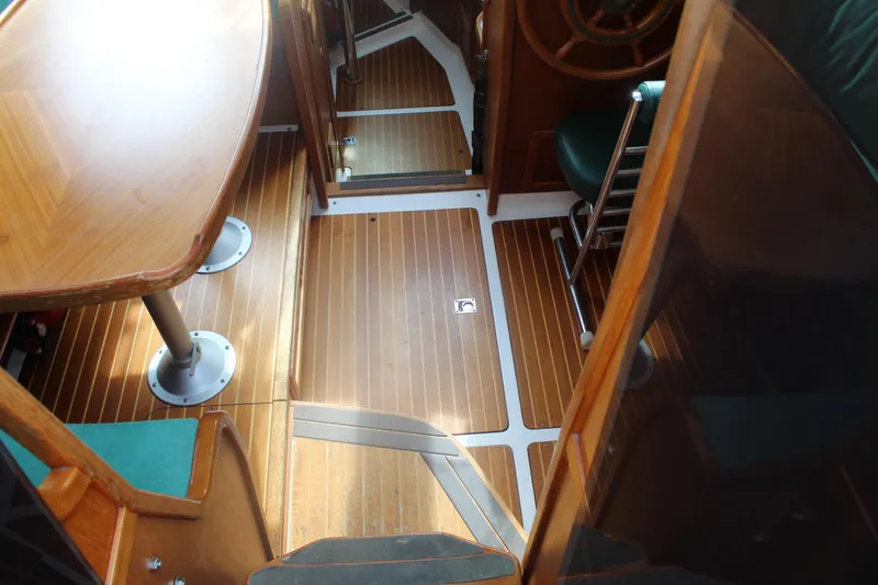 Slide: The Image of Interior of 1998 Nauticat 32 Pilothouse with wooden flooring and seating area. - 8