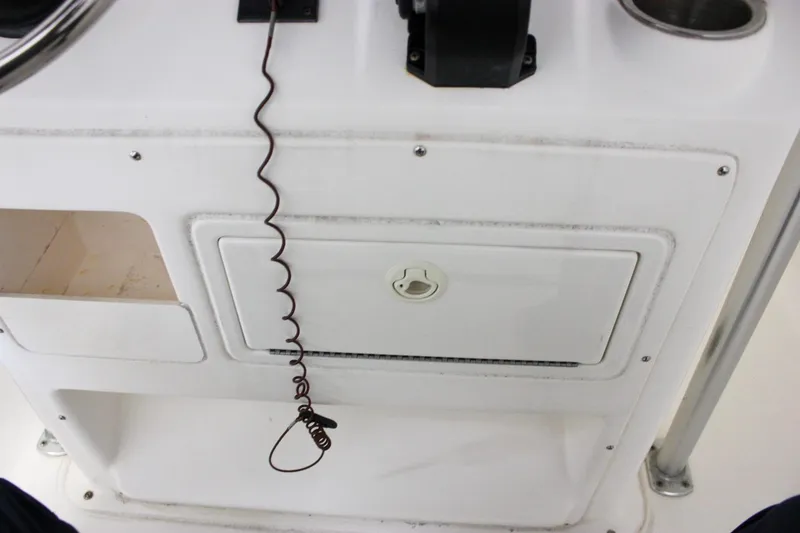 Slide: The Image of Console of 2006 Sea Hunt Triton 207 boat with storage compartment and coiled cord. - 10