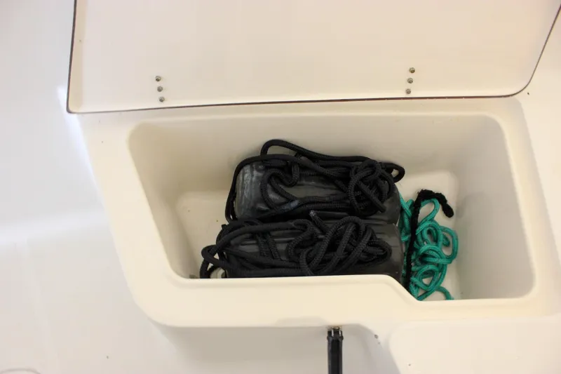 Slide: The Image of Storage compartment with ropes on a 2006 Sea Hunt Triton 207 boat. - 13