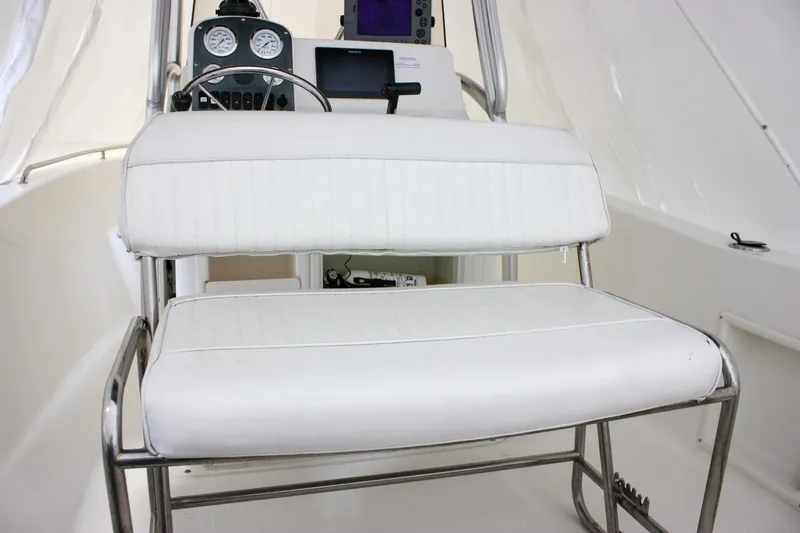 Slide: The Image of 2006 Sea Hunt Triton 207 boat interior with white seating and control panel. - 18
