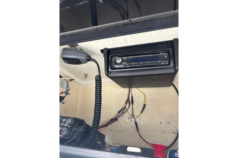 Slide: The Image of 2006 Sea Hunt Triton 207 boat radio and communication equipment setup. - 25