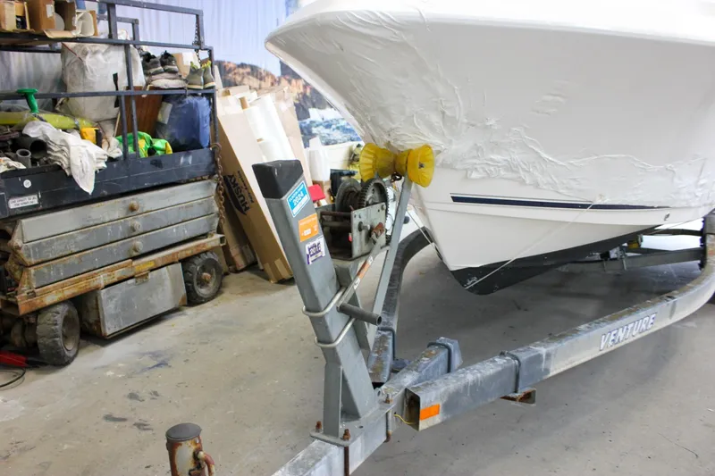 Slide: The Image of 2006 Sea Hunt Triton 207 boat on trailer in a garage setting. - 31