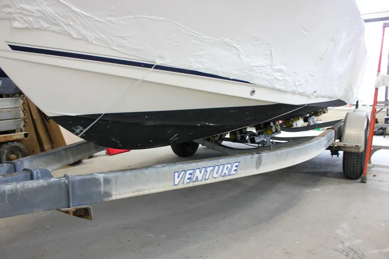 Slide: The Image of 2006 Sea Hunt Triton 207 boat on Venture trailer in a garage. - 32