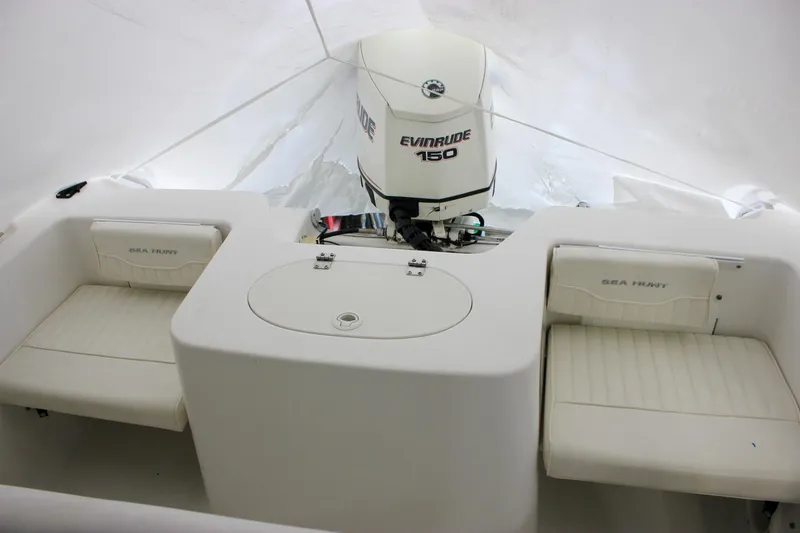 Slide: The Image of 2006 Sea Hunt Triton 207 boat interior with Evinrude 150 engine, featuring white seating. - 4