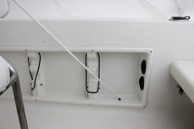 Slide: The Image of 2006 Sea Hunt Triton 207 boat interior with storage compartment and rod holder. - 5