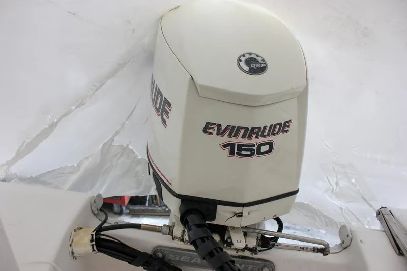 Slide: The Image of 2006 Sea Hunt Triton 207 with Evinrude 150 outboard motor. - 6