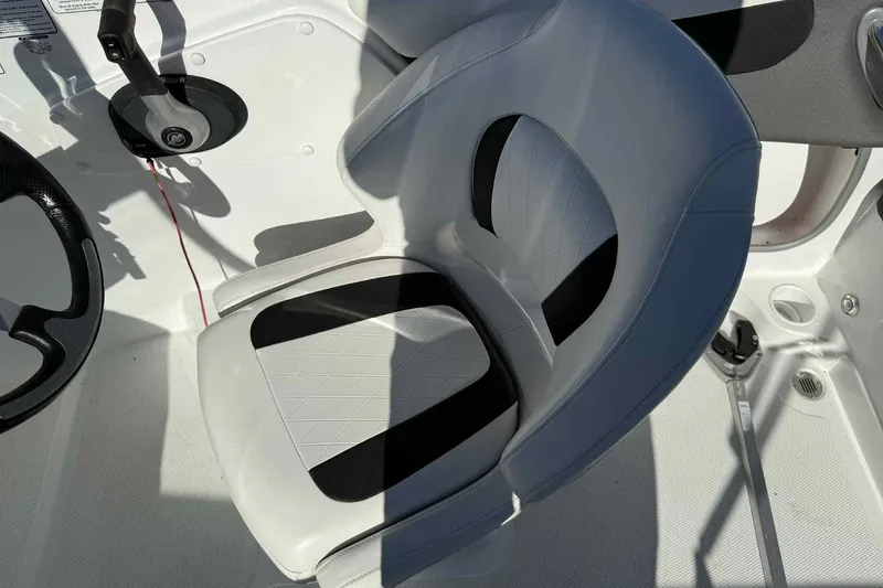 Slide: The Image of 2021 Tahoe 550 TS boat interior with steering wheel and cushioned seat. - 12