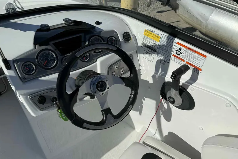 Slide: The Image of 2021 Tahoe 550 TS boat dashboard with steering wheel and control panel. - 13