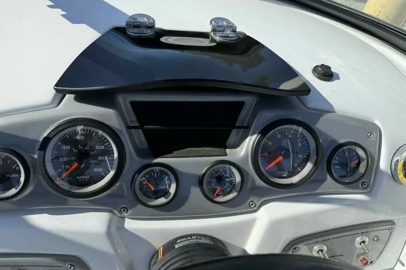 Slide: The Image of Dashboard of a 2021 Tahoe 550 TS boat with gauges and controls. - 14