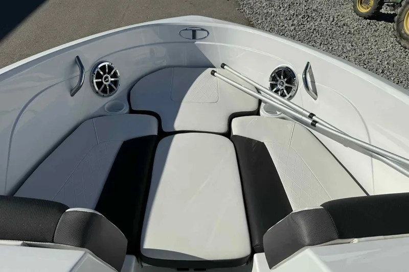Slide: The Image of 2021 Tahoe 550 TS boat interior with cushioned seating and speakers. - 15