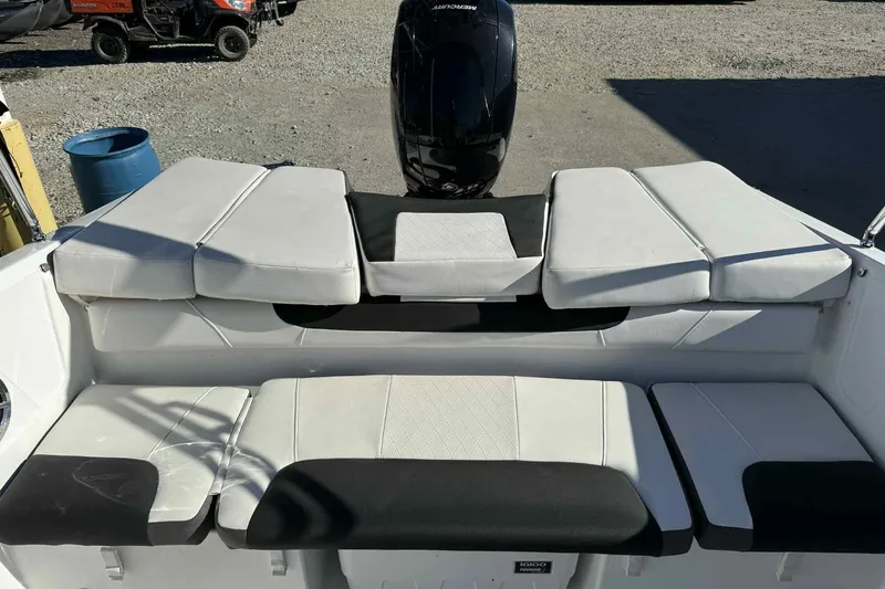Slide: The Image of 2021 Tahoe 550 TS boat interior with cushioned seating and outboard motor. - 8