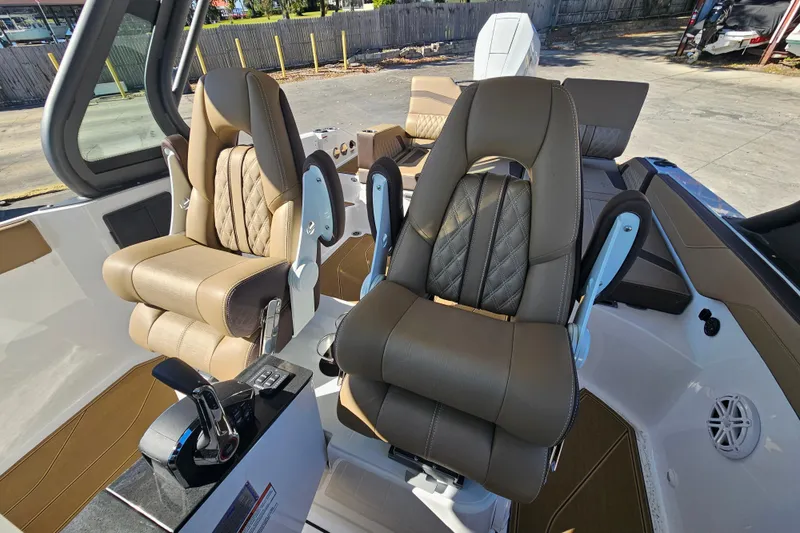 Slide: The Image of Luxurious seating in the 2026 Monterey Elite 27 OB boat, featuring premium upholstery and controls. - 12