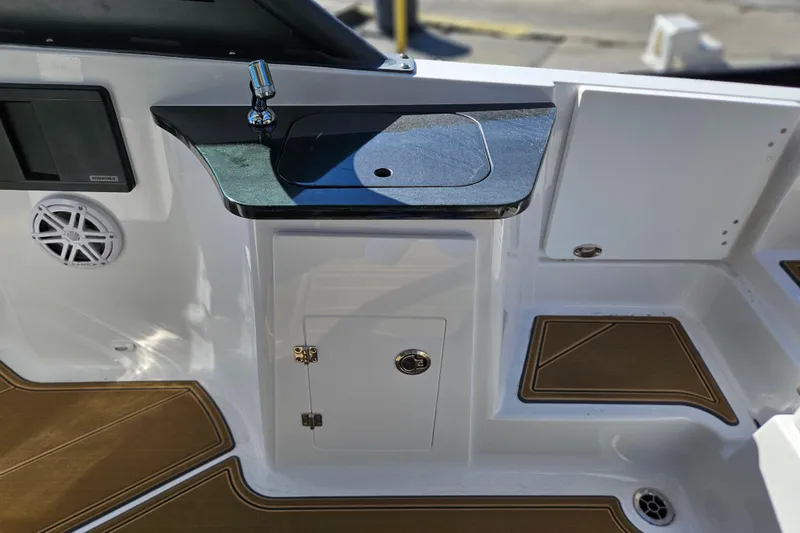 Slide: The Image of 2026 Monterey Elite 27 OB boat interior with sink and storage area. - 13