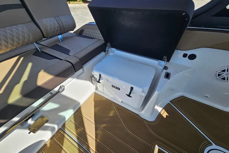 Slide: The Image of 2026 Monterey Elite 27 OB boat interior with seating and storage compartment. - 17