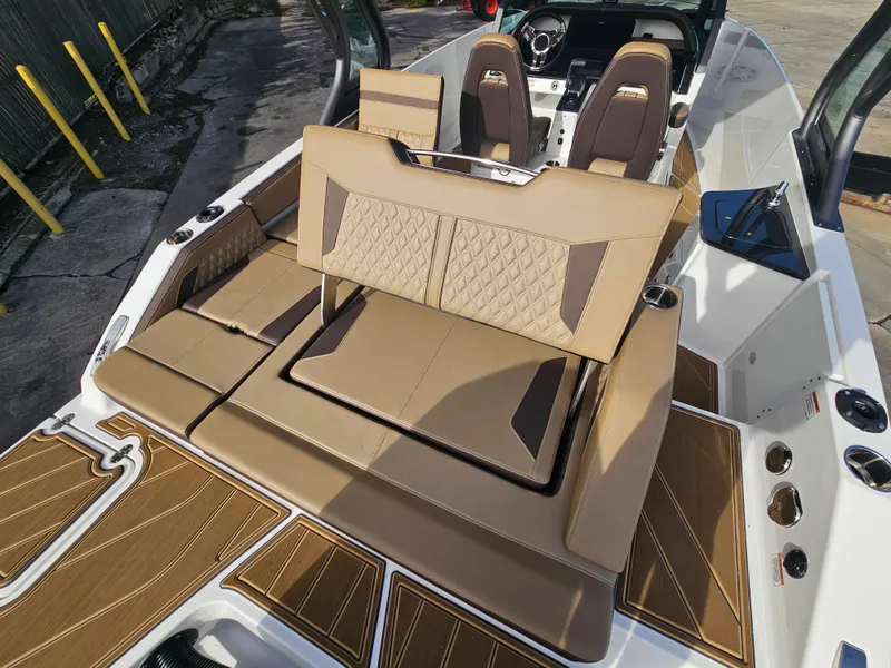 Slide: The Image of 2025 Monterey Elite 27 OB boat interior with tan seating and modern design. - 19