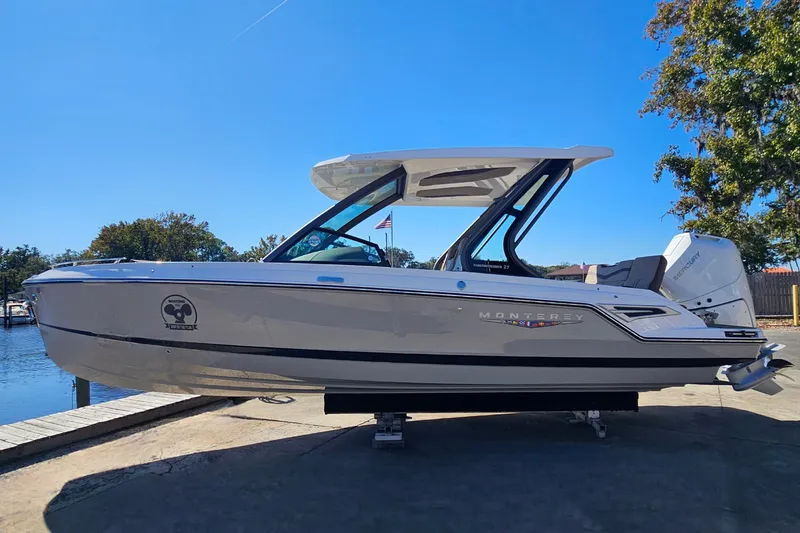 Slide: The Image of 2026 Monterey Elite 27 OB boat docked under clear blue sky. - 2