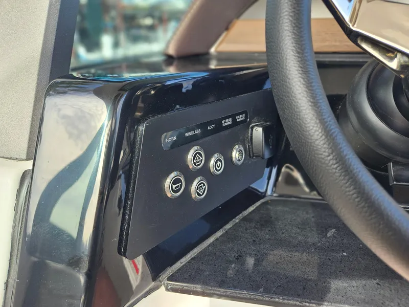 Slide: The Image of Control panel of 2025 Monterey Elite 27 OB boat, featuring various function buttons. - 27