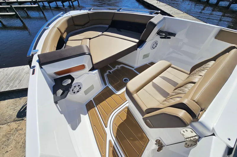 Slide: The Image of Luxurious seating on the 2026 Monterey Elite 27 OB boat, docked by the water. - 32