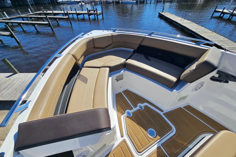 Slide: The Image of Luxurious seating on the 2026 Monterey Elite 27 OB boat, docked by the water. - 37