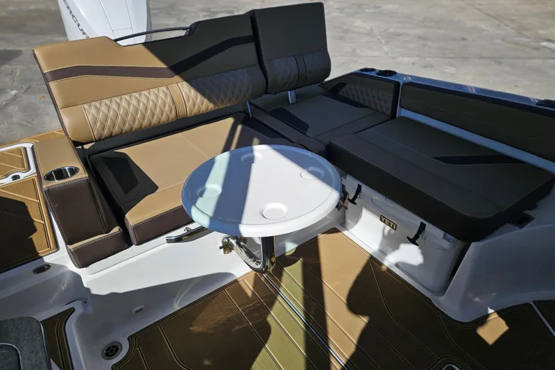 Slide: The Image of Luxurious seating area on 2026 Monterey Elite 27 OB boat with table and storage. - 41