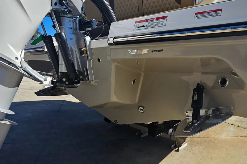 Slide: The Image of 2026 Monterey Elite 27 OB boat stern with outboard motor and trim tabs. - 45