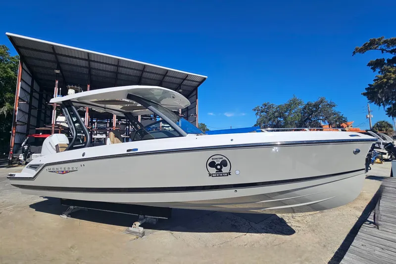 Slide: The Image of 2026 Monterey Elite 27 OB boat displayed outdoors under clear blue sky. - 6