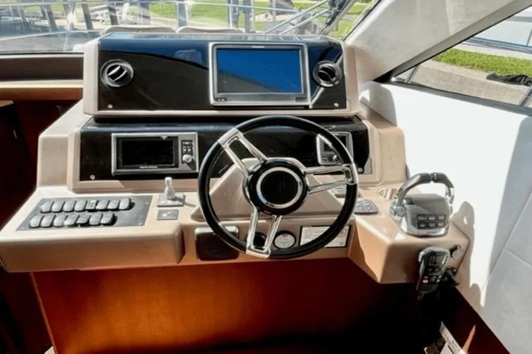 Slide: The Image of Helm of 2017 Galeon 380 Fly yacht with modern controls and navigation system. - 12