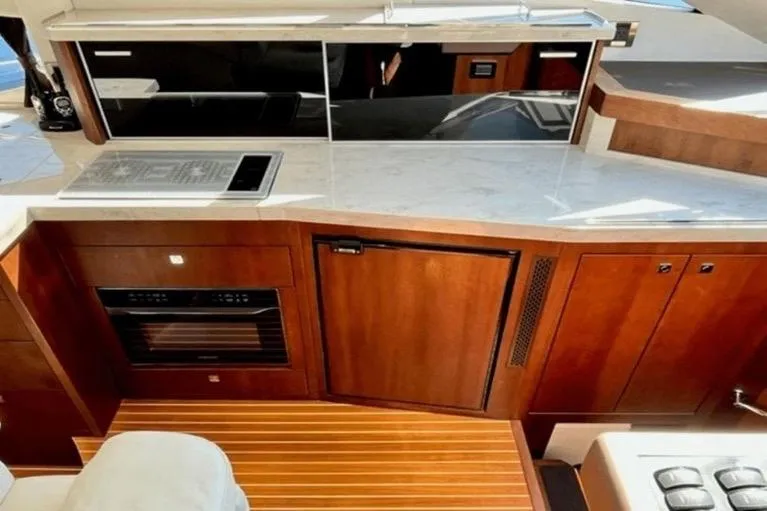 Slide: The Image of Luxurious kitchen area in 2017 Galeon 380 Fly yacht with modern appliances and wood finish. - 13