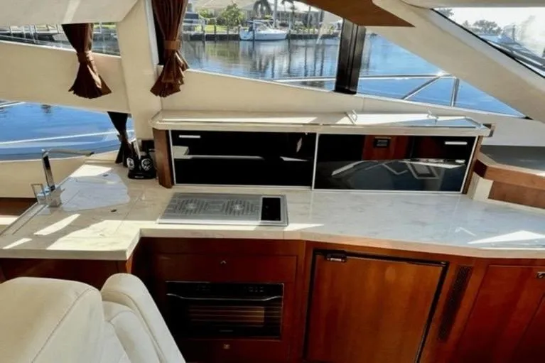 Slide: The Image of Luxurious interior of 2017 Galeon 380 Fly yacht with modern kitchen and scenic window view. - 14