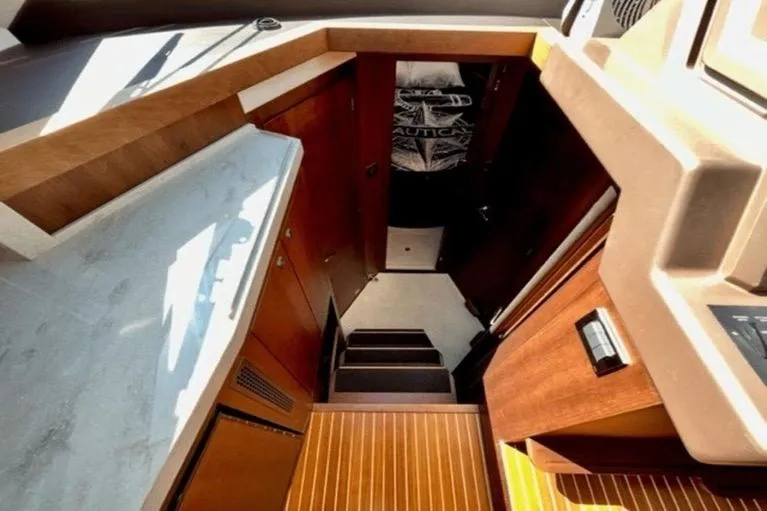 Slide: The Image of Interior view of 2017 Galeon 380 Fly yacht with wooden finishes and stairs. - 16