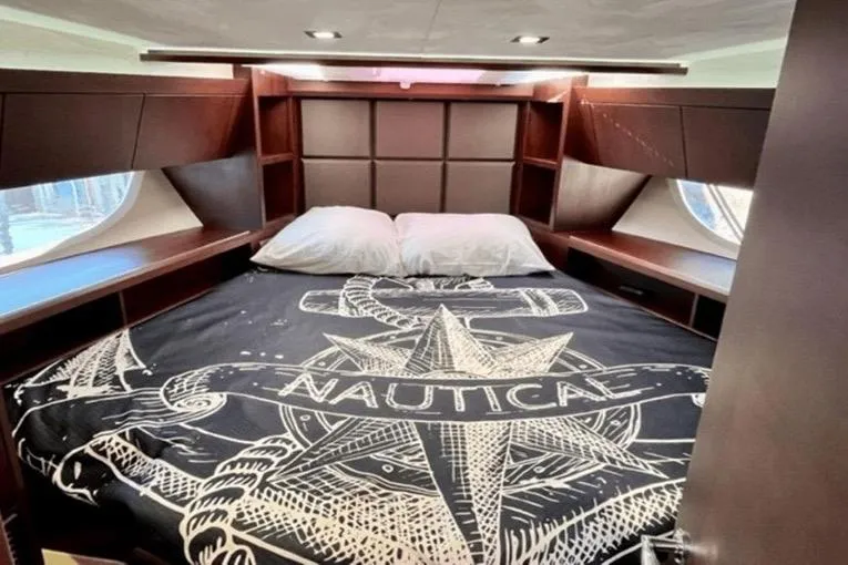 Slide: The Image of Luxurious bedroom in 2017 Galeon 380 Fly yacht with nautical-themed bedding. - 18