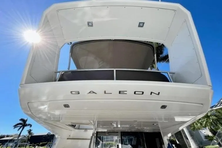 Slide: The Image of 2017 Galeon 380 Fly yacht, rear view under sunny blue sky. - 2