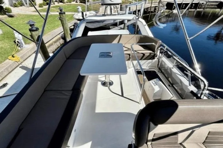 Slide: The Image of 2017 Galeon 380 Fly yacht with spacious deck and seating area by the water. - 5